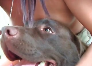 Dark-haired beauty happily fucks a dog