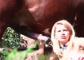Blonde whore is having bestial fun with a horny stallion