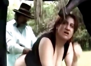 Redheaded with lots of meat on her body bangs a horse