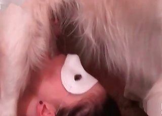 Masked whore sucks a doggy